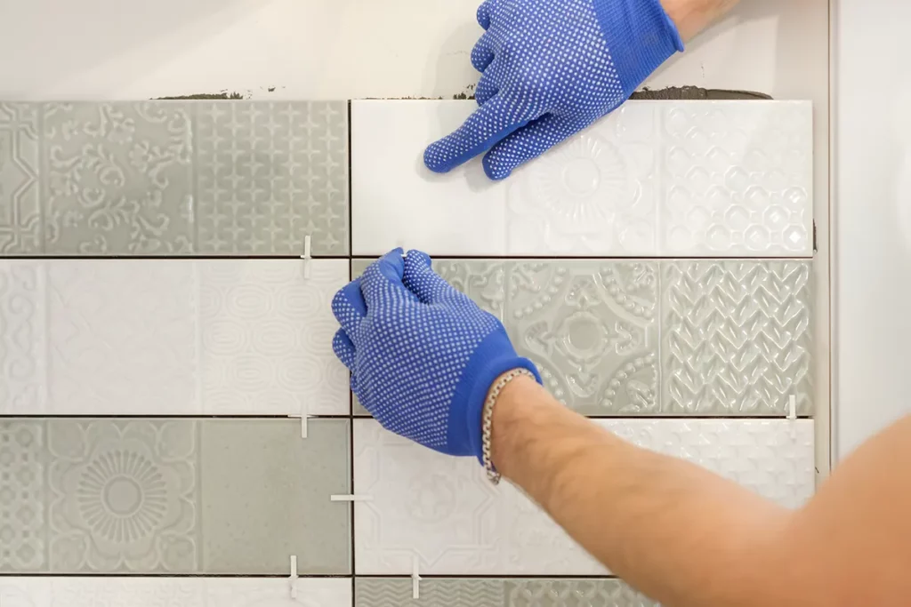 installing ceramic tiles on the wall in kitchen