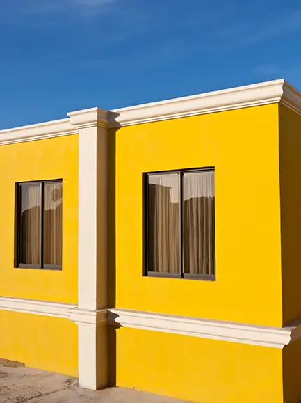 Bright yellow exterior house with white trim.