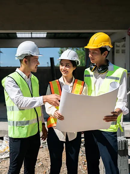 Construction team reviewing blueprints on a general contractor site